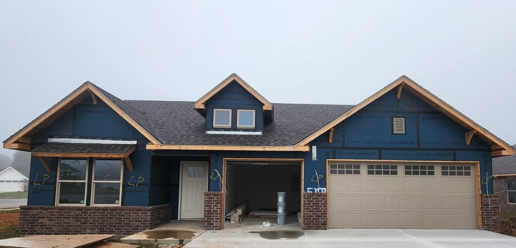 New construction home with exterior trim and carpentry work in progress in Springfield Missouri