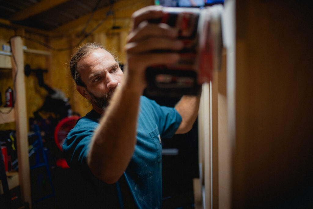 Dustin Dalton with Dalton custom carpenters of Springfield Missouri works on a custom entertainment center in his shop. 