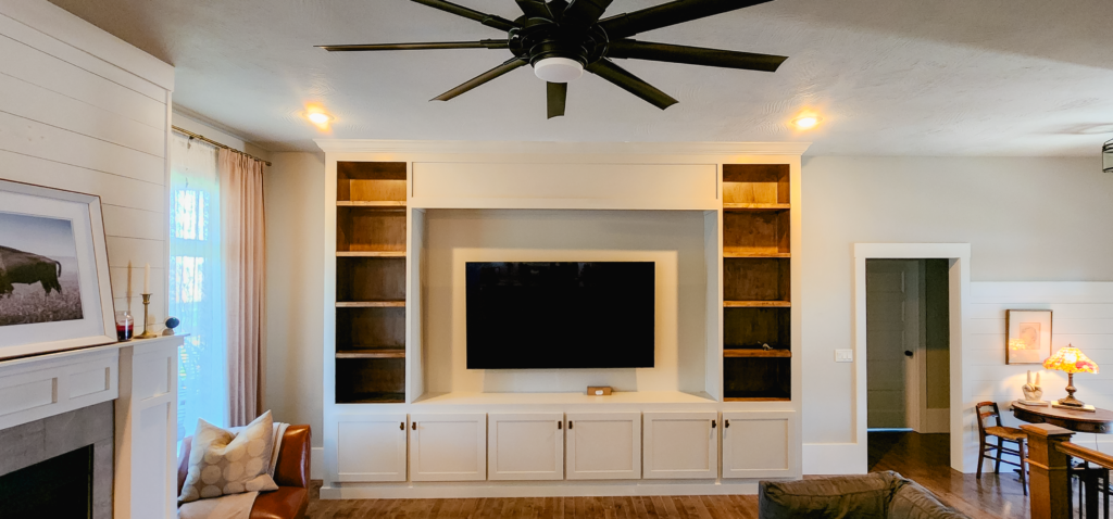 Custom carpenter installing a built-in in the Missouri Ozarks